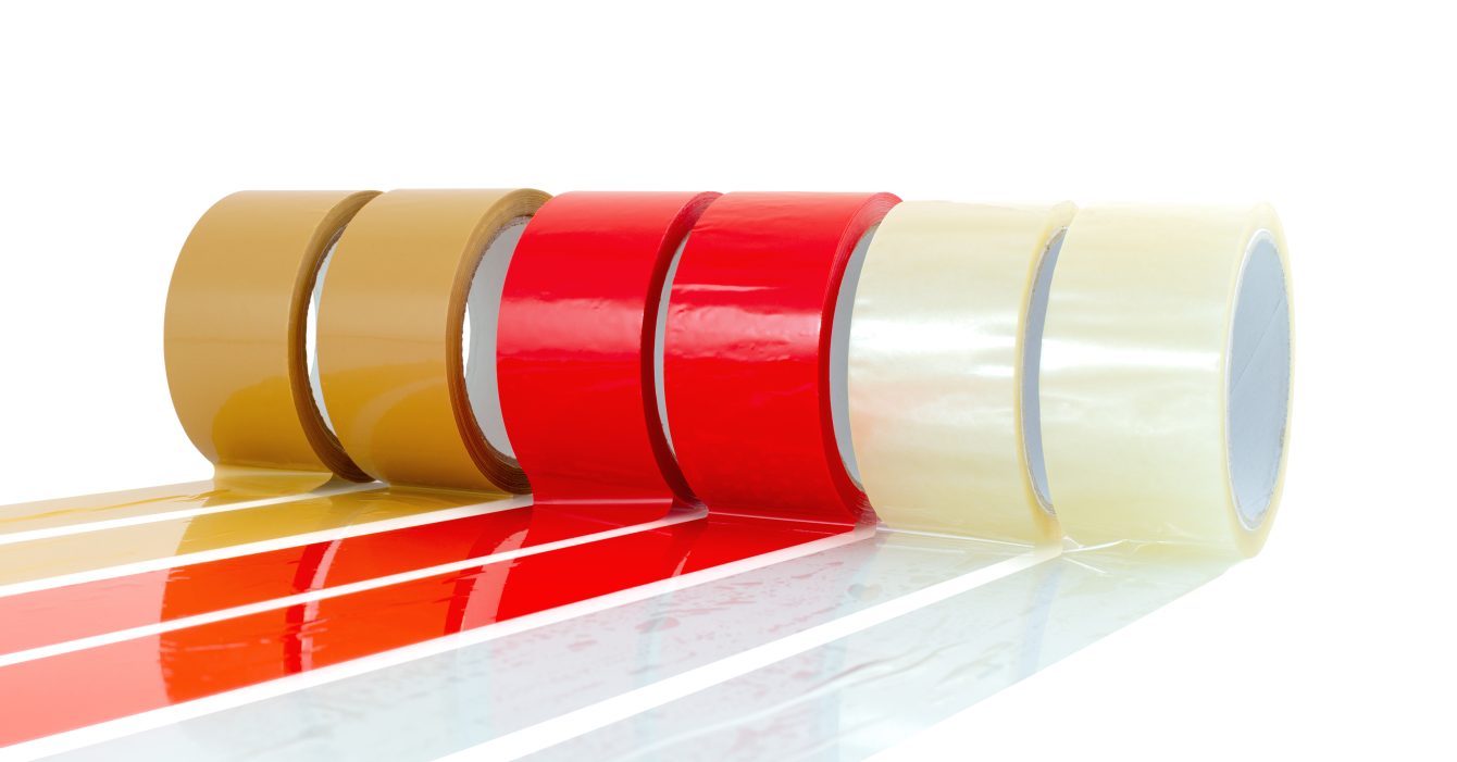 Brown, red and transparent (clear) adhesive tape isolated on white background with shadow reflection - clipping paths. Reels of sticky tapes.  Parcel packing equipment wallpaper.
